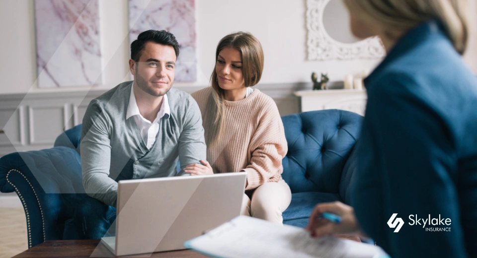 insurance agent helping a homeowners couple in florida